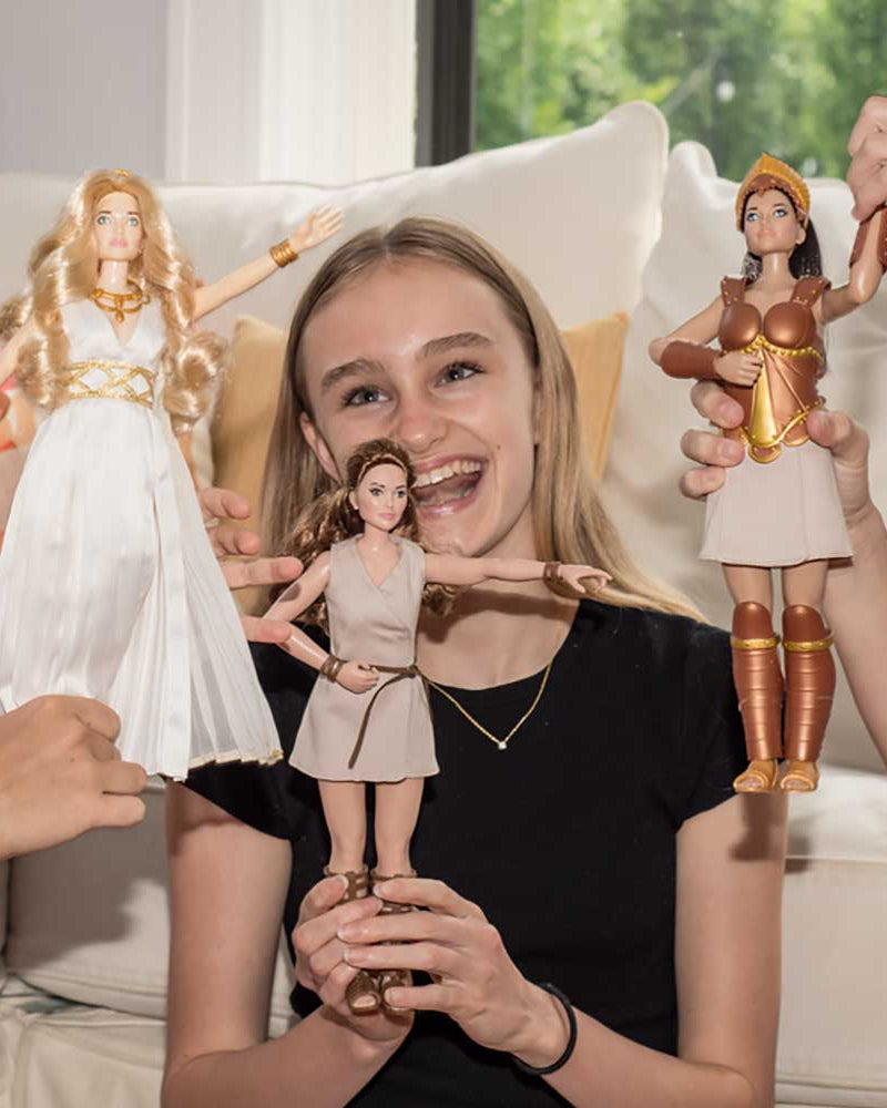 Girl with Artemis doll, flanked by others holding Venus and Athena dolls