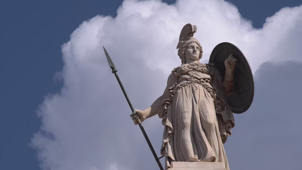 Statue of Athena against a sky of moving clouds